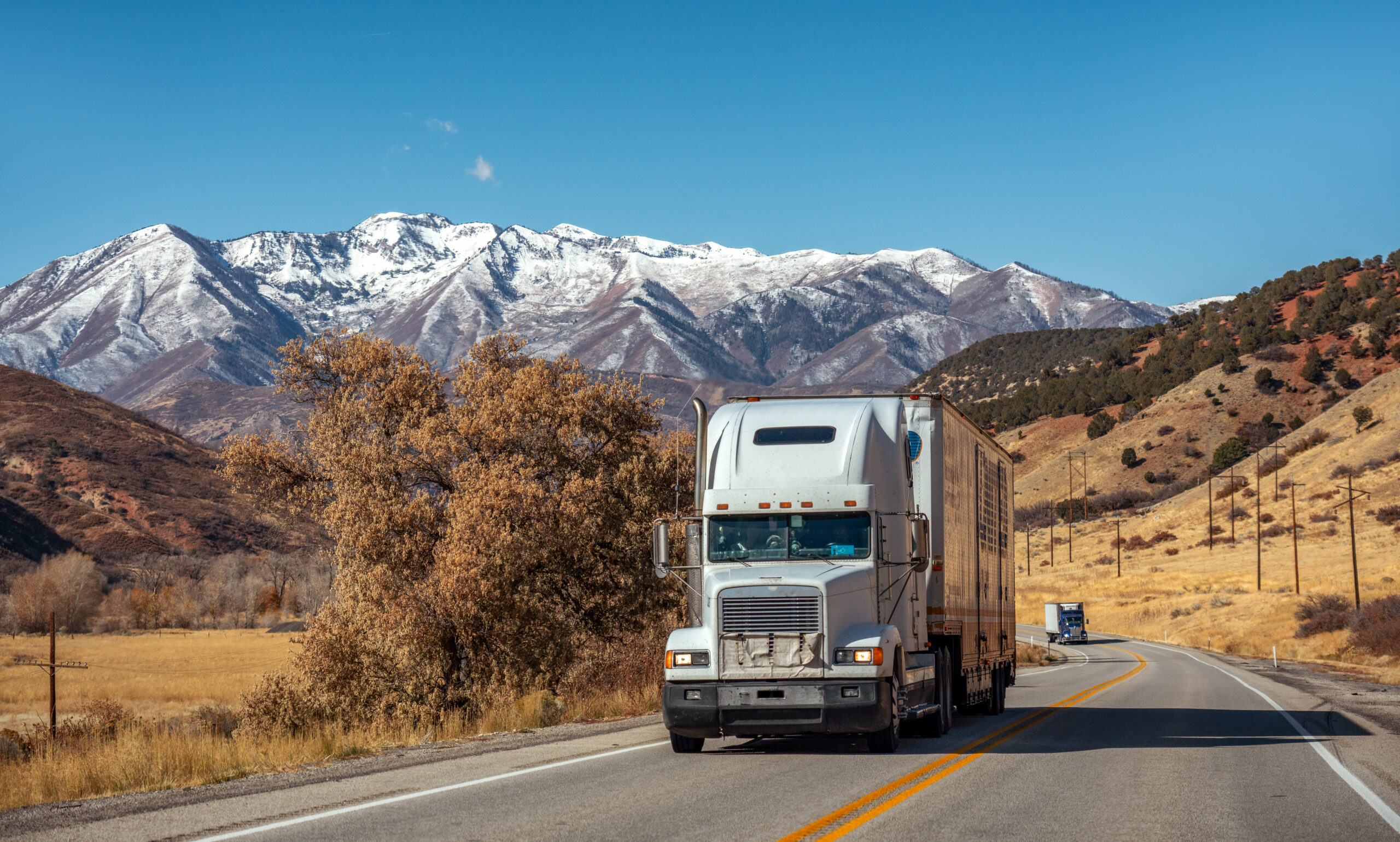 Freight truck on highway with mountains.